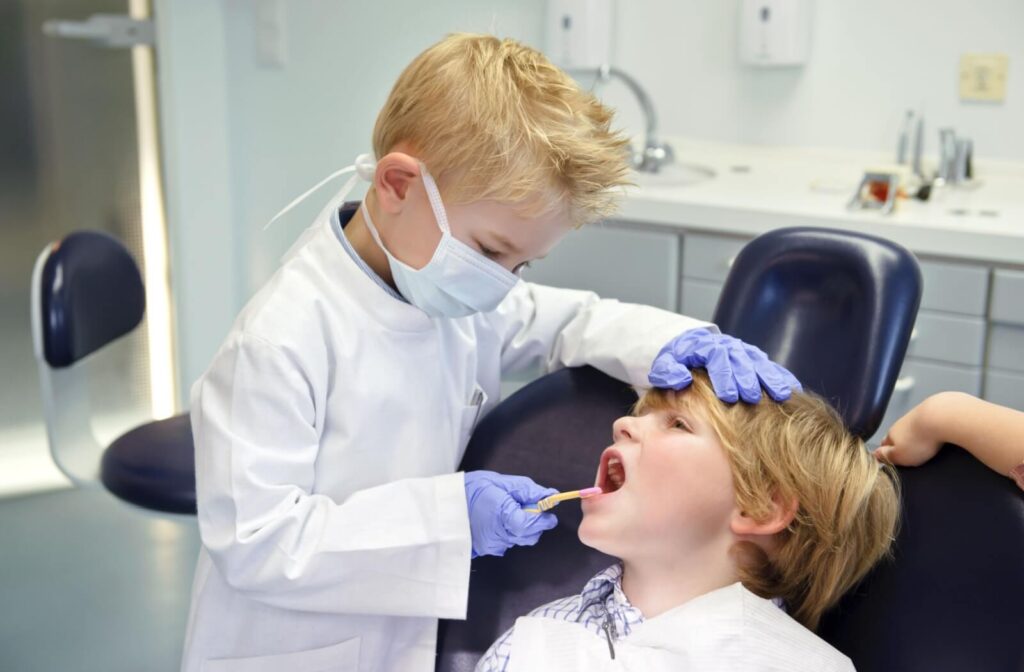 Two young boys pretend to be a dentist and a patient.